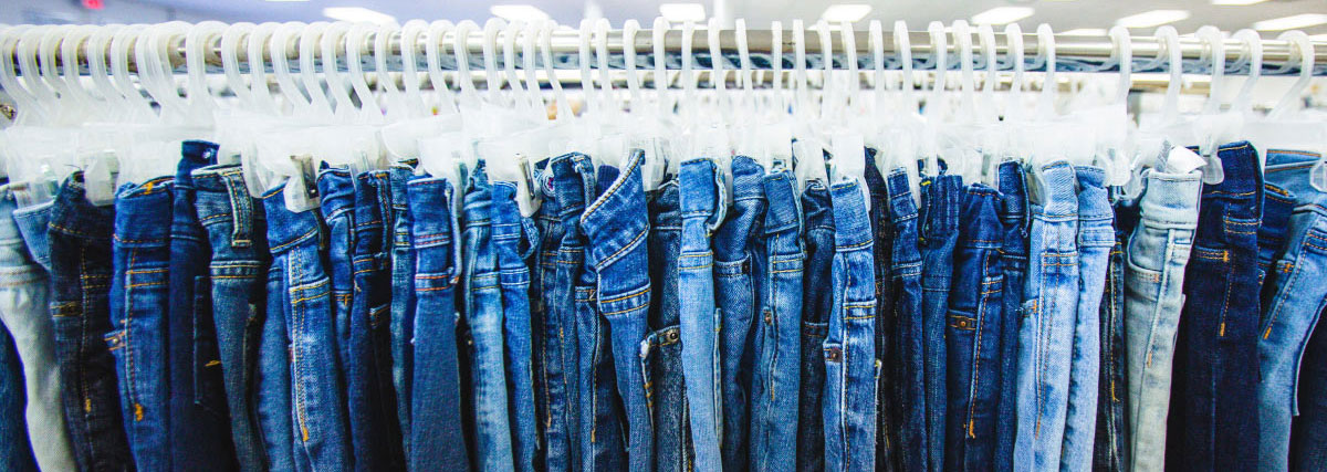 various pairs of jeans on a clothing rack