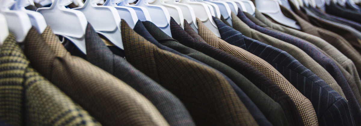 various suit jackets on a rack