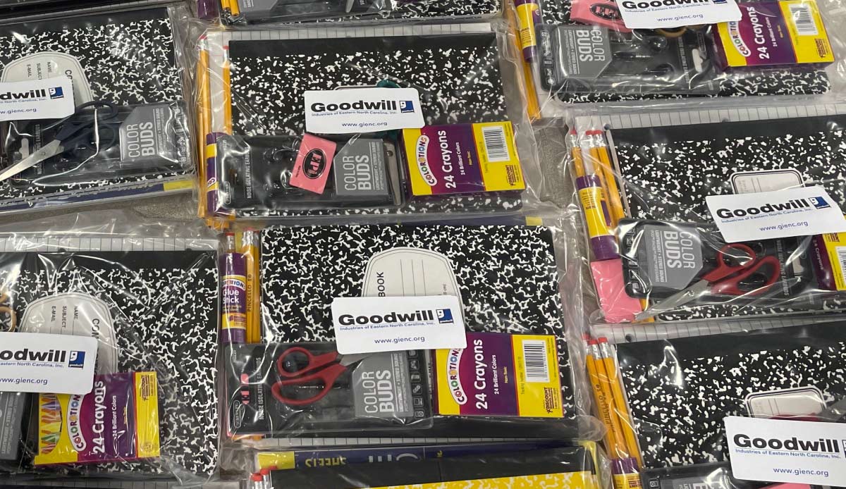 school donation packs containing notebooks, crayons, and other items